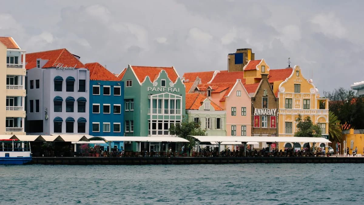 A row of colorful buildings next to a body of water